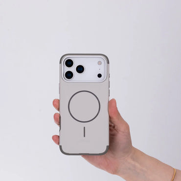 Phone case with a circular design held by a hand on a light gray background