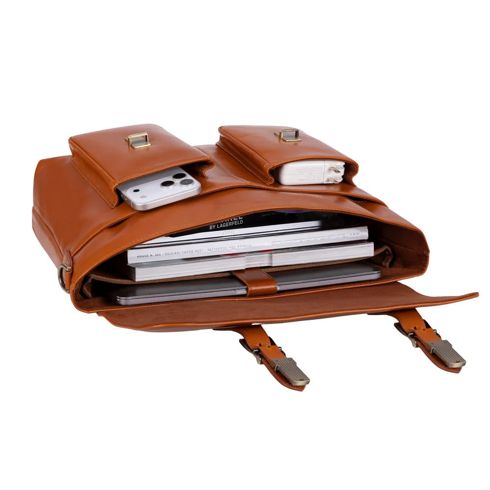 A brown leather briefcase or laptop bag shown open on a white background, with a smartphone and small accessories stored in the exterior pockets and a stack of notebooks inside the main compartment.