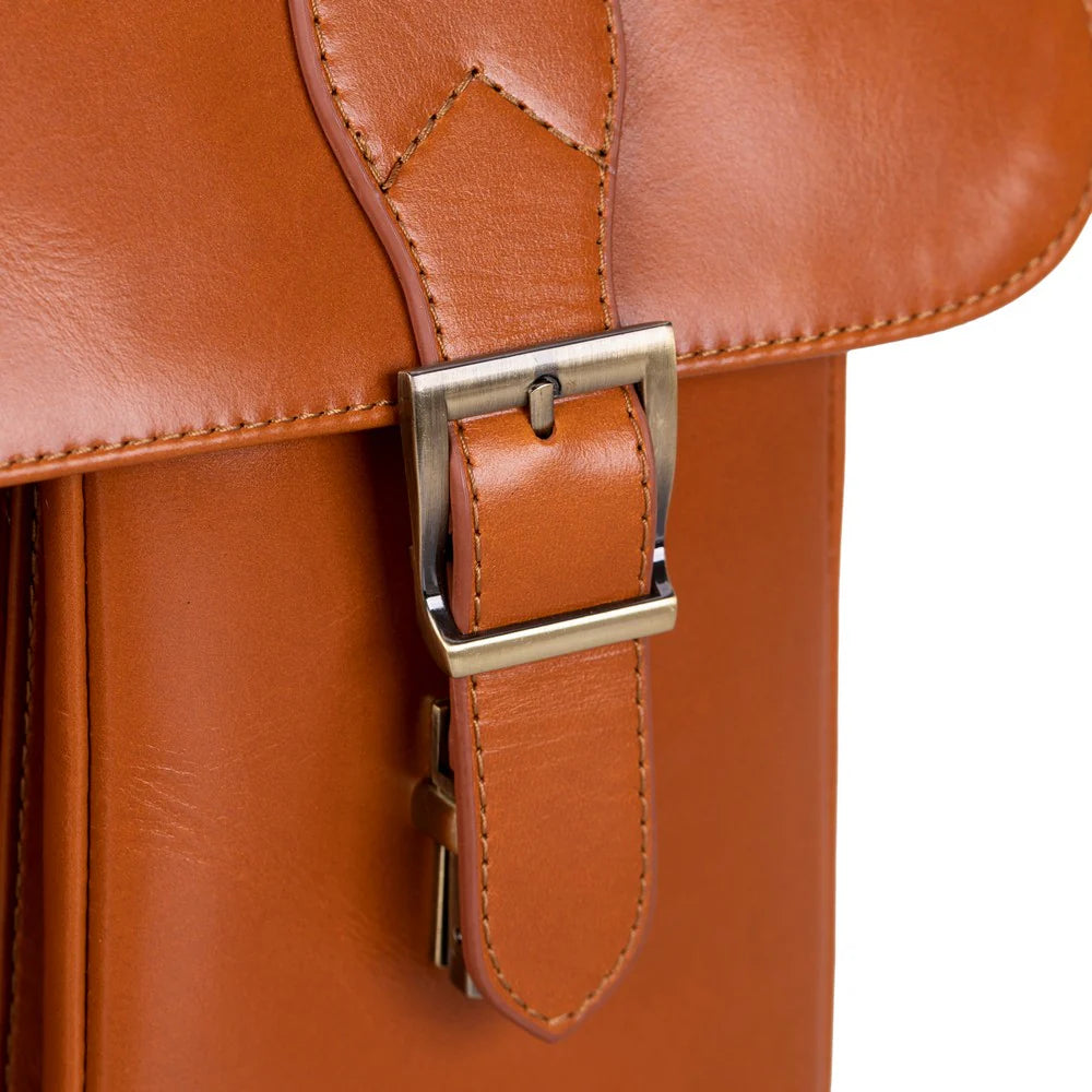 Close-up of a brown leather bag with a silver metal buckle closure on a white background.