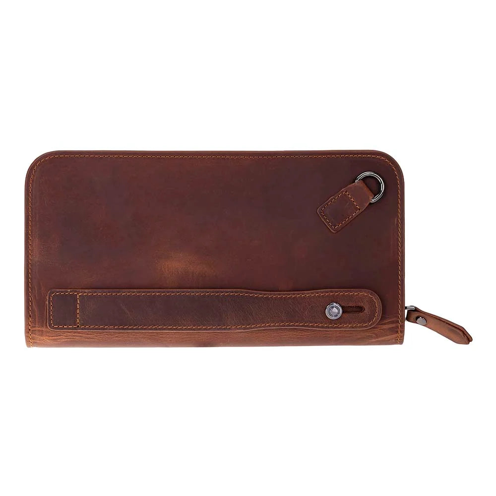 A brown leather zip-around wallet with a wrist strap and metal snap button, shown on a plain white background.